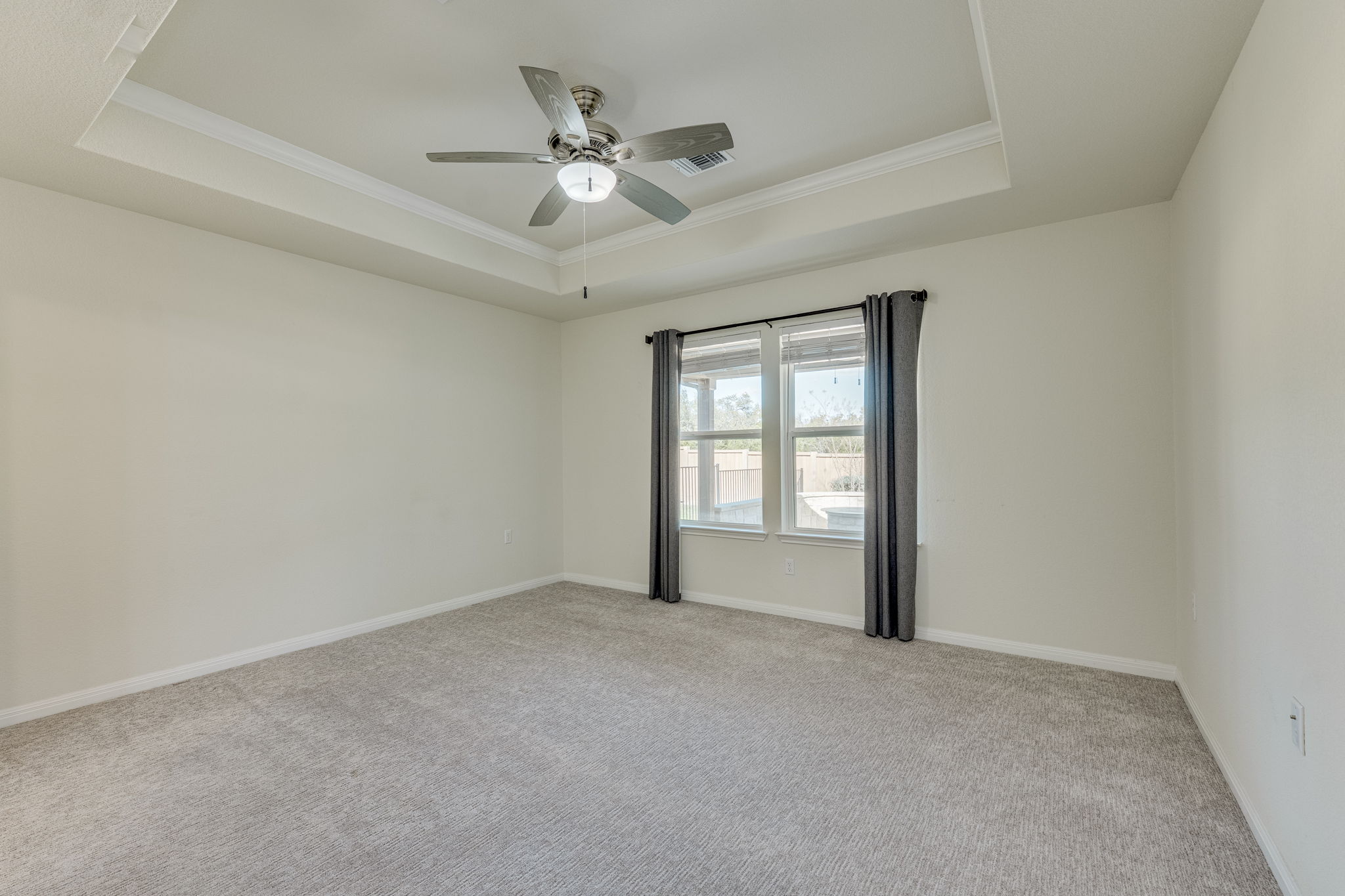 509 Rockport Street Georgetown, TX 78633 - Photo 13 of 27 Master bedroom with tray ceiling, upgraded carpet installed in 2025