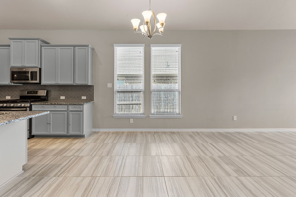 2666 Cedar Path Lane Conroe, TX 77385 - Photo 8 of 22 a kitchen with stainless steel appliances granite countertop a stove a sink and white cabinets with wooden floor