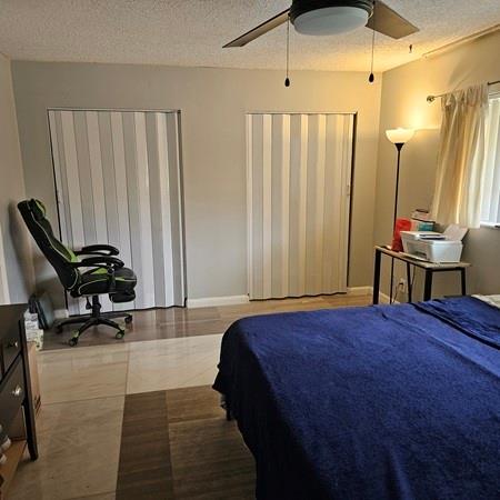 3270 North Pine Island Road, Unit 307 Sunrise, FL 33351 - Photo 17 of 17 a bedroom with a bed a desk and chair