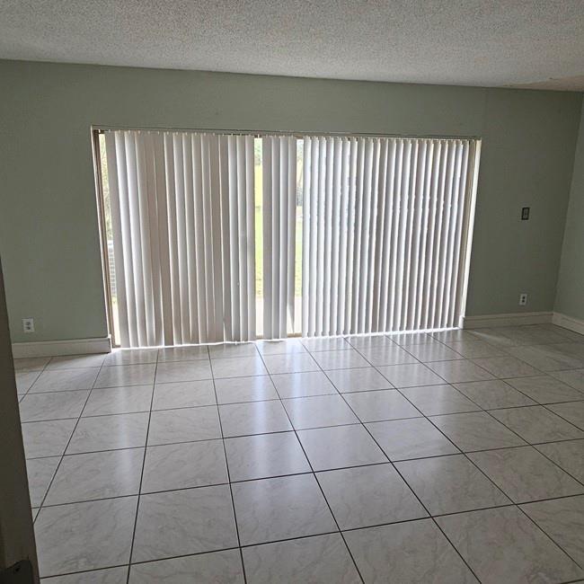 3270 North Pine Island Road, Unit 307 Sunrise, FL 33351 - Photo 10 of 17 a view of a livingroom with an empty space and a window