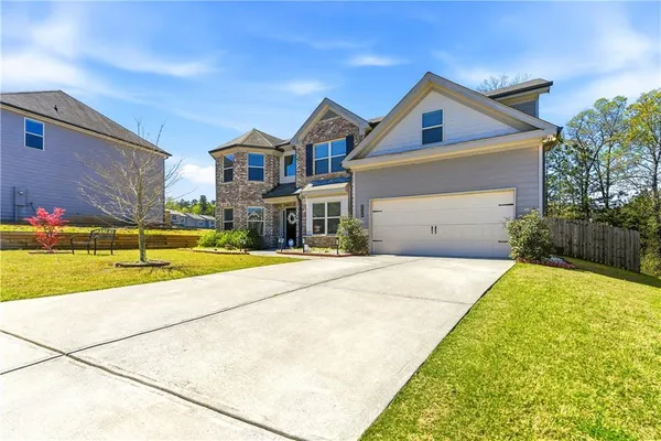 a front view of a house with a yard