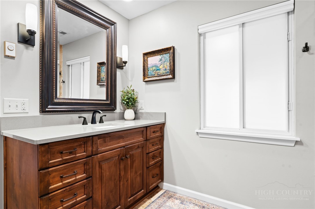 220 Woodwinds Lane Seven Devils, NC 28604 - Photo 19 of 46 a bathroom with a sink and a mirror