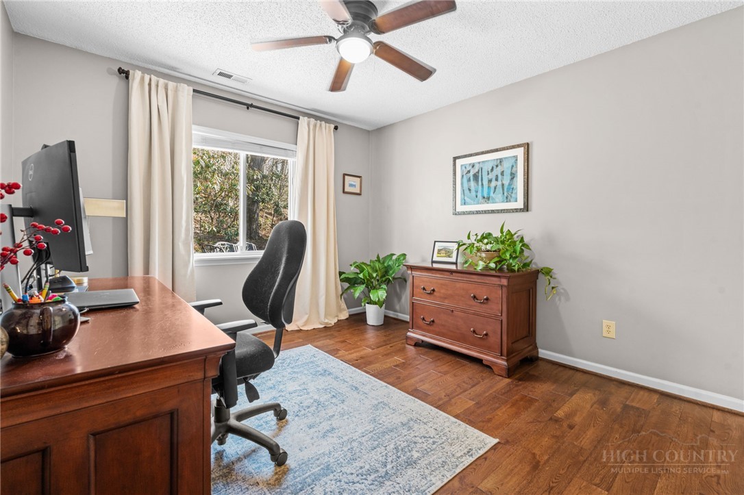 220 Woodwinds Lane Seven Devils, NC 28604 - Photo 21 of 46 a view of a workspace with furniture and a window