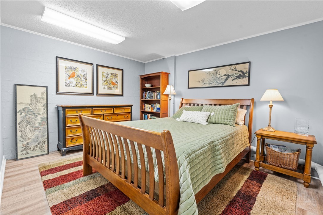 220 Woodwinds Lane Seven Devils, NC 28604 - Photo 26 of 46 a bedroom with a bed and painting on the wall