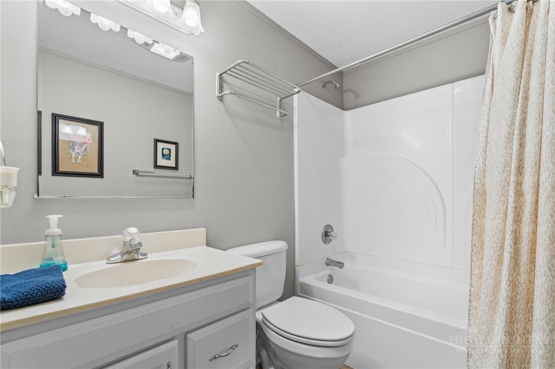 220 Woodwinds Lane Seven Devils, NC 28604 - Photo 27 of 46 a bathroom with a sink a mirror a toilet and a bathtub