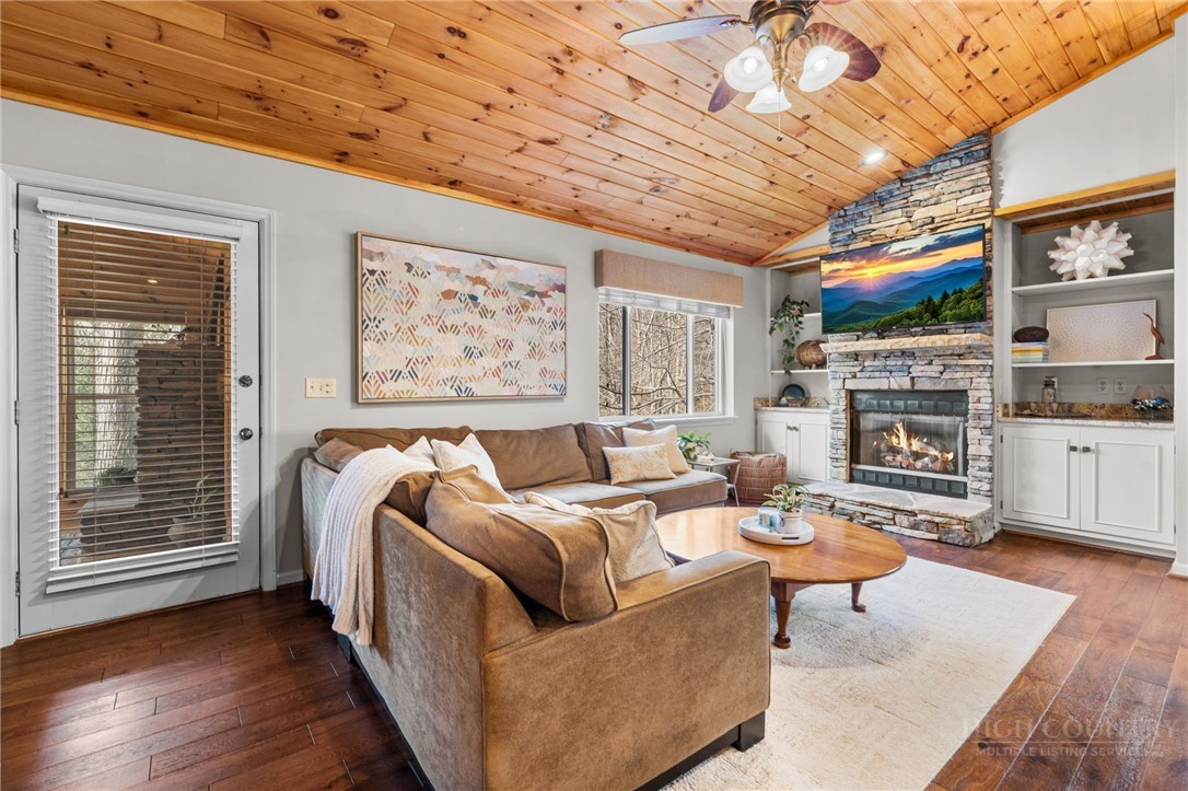 220 Woodwinds Lane Seven Devils, NC 28604 - Photo 5 of 46 a living room with furniture and a fireplace