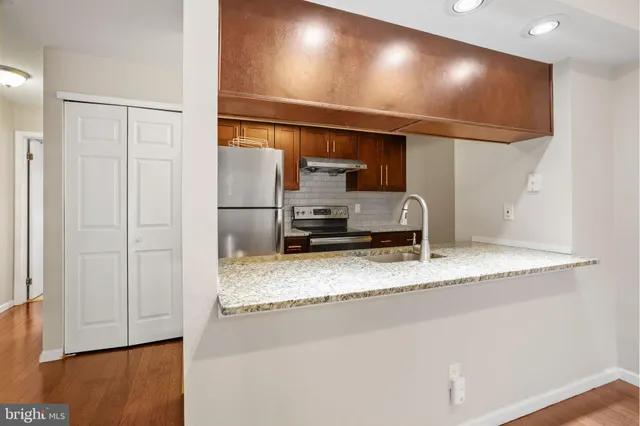 a kitchen with a refrigerator and a sink