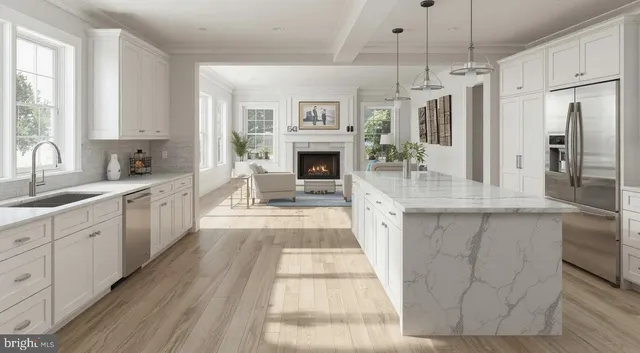 a large kitchen with cabinets a counter space a sink and stainless steel appliances