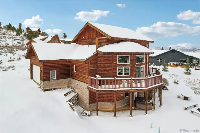 a roof deck with table and chairs