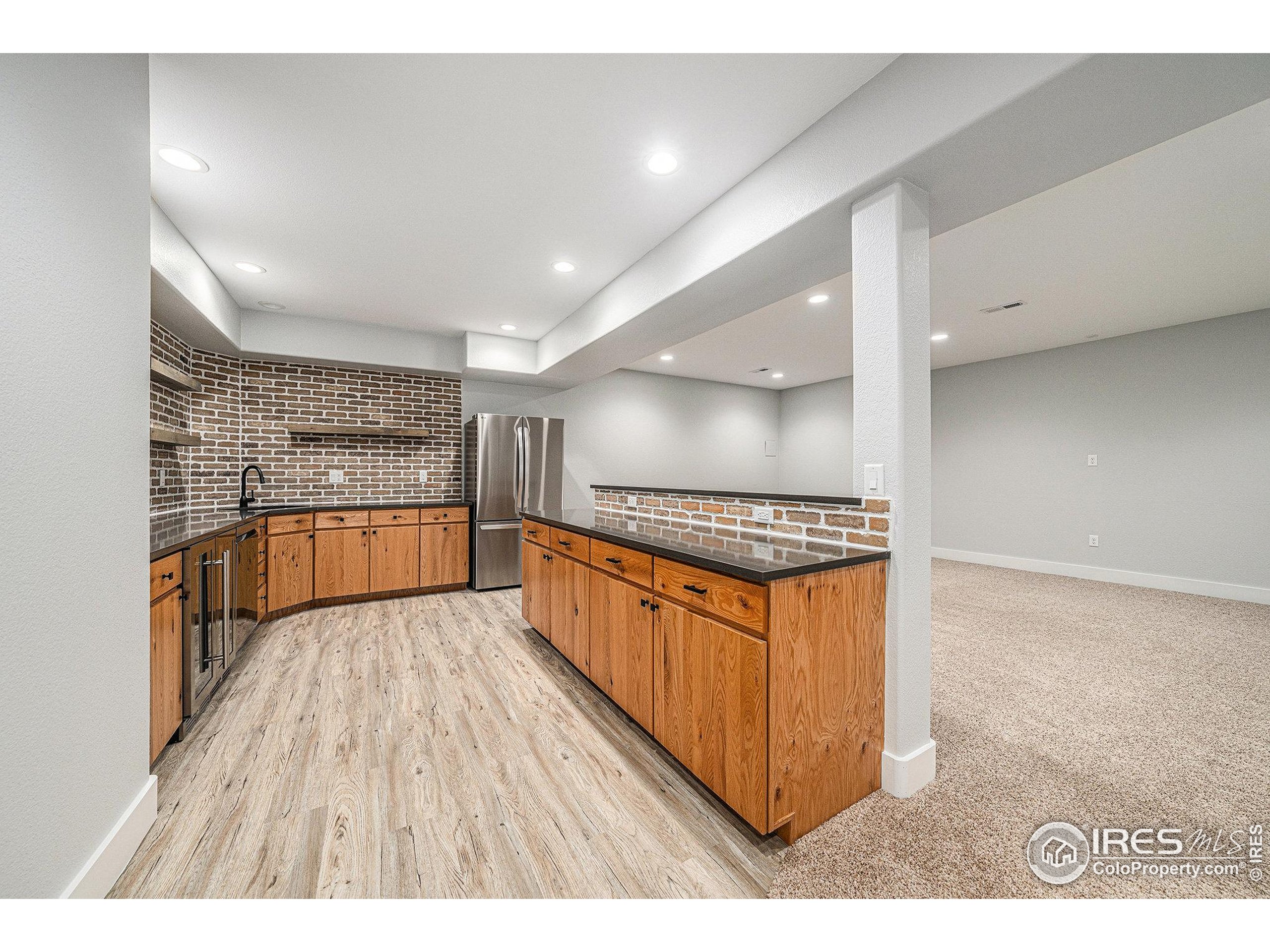 796 Abrams Way Berthoud, CO 80513 - Photo 19 of 40 a kitchen with stainless steel appliances granite countertop a stove a sink and a refrigerator