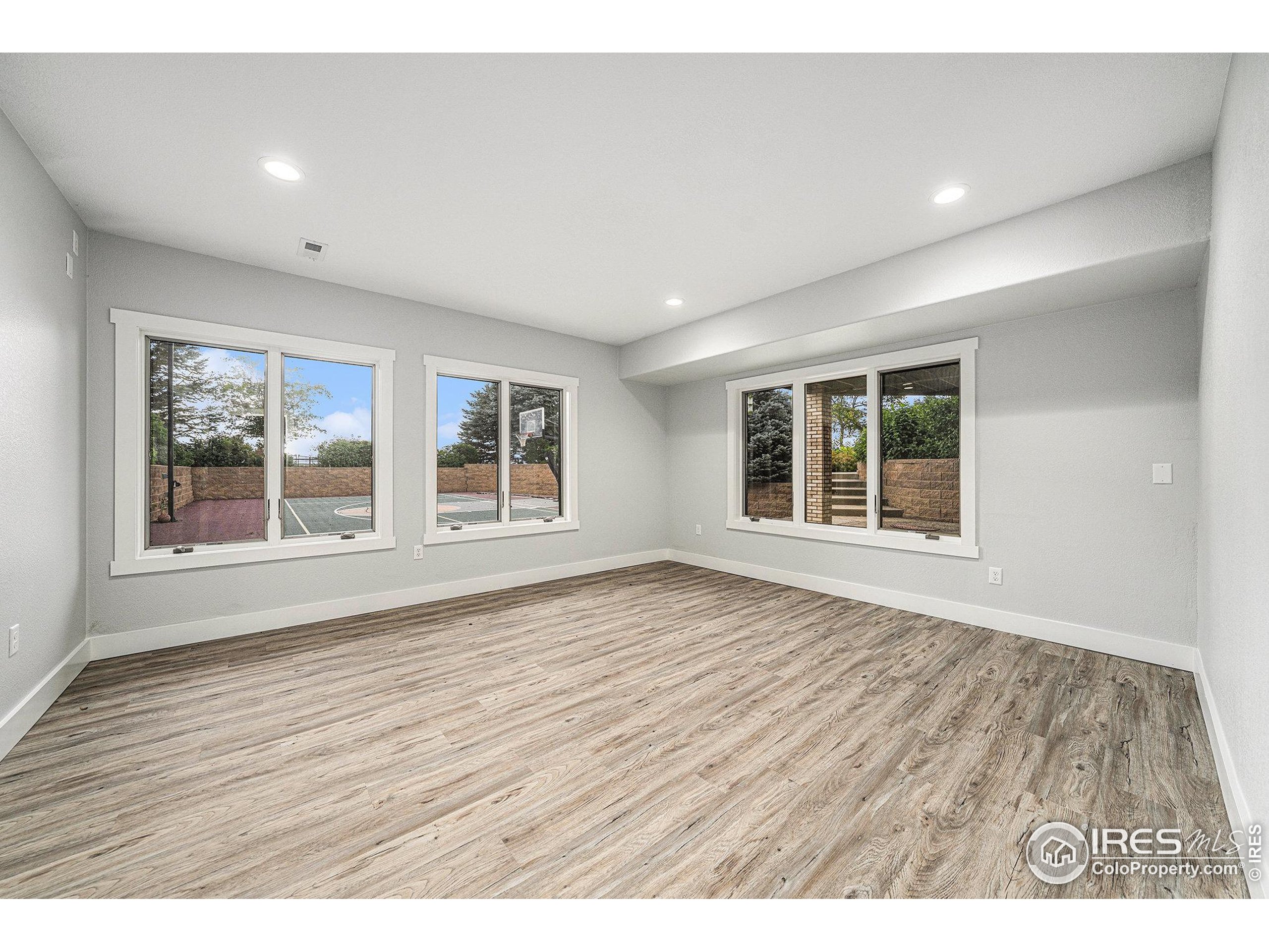 796 Abrams Way Berthoud, CO 80513 - Photo 20 of 40 wooden floor in an empty room with a window