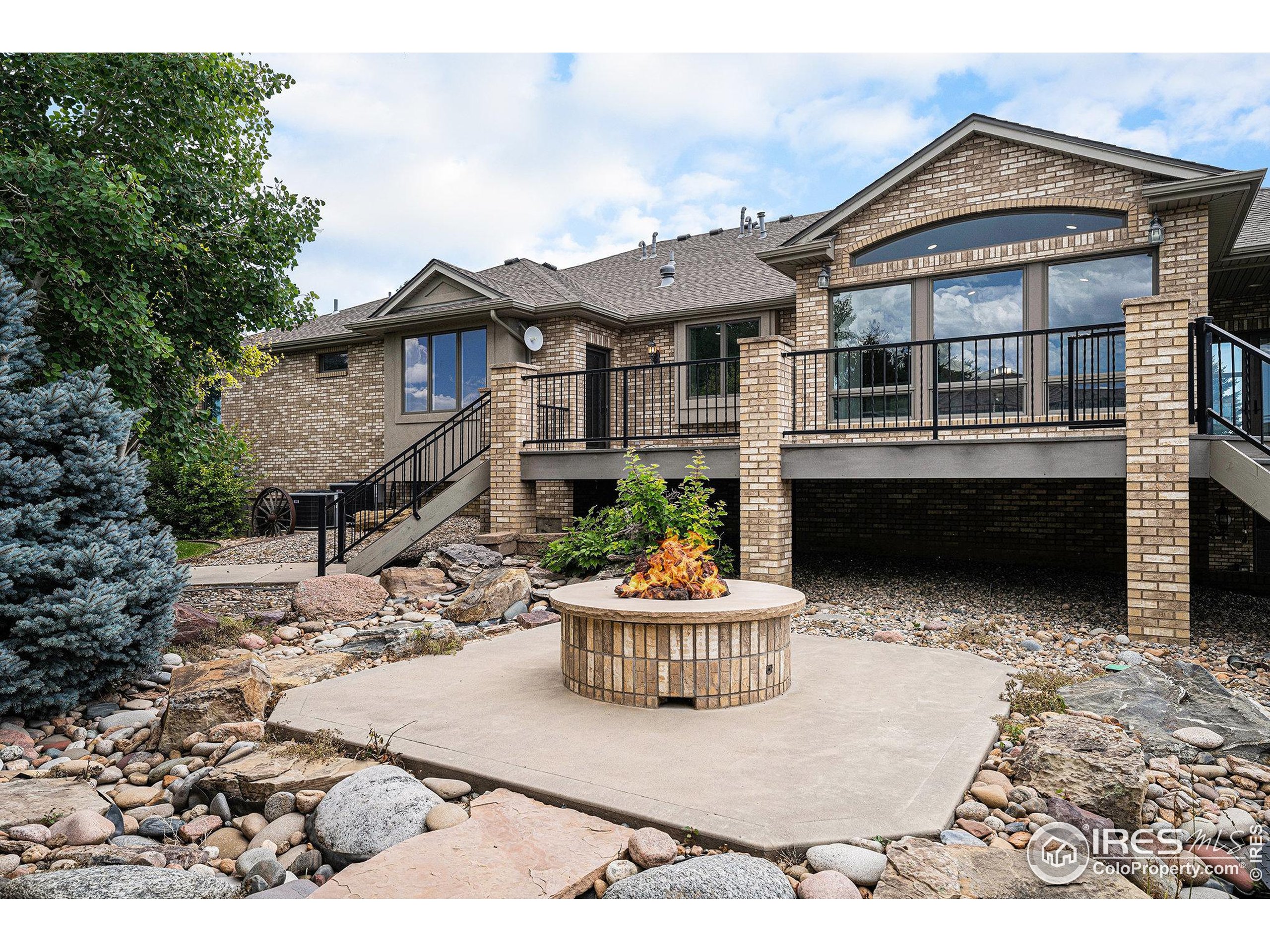 796 Abrams Way Berthoud, CO 80513 - Photo 22 of 40 a front view of a house with a yard and potted plants