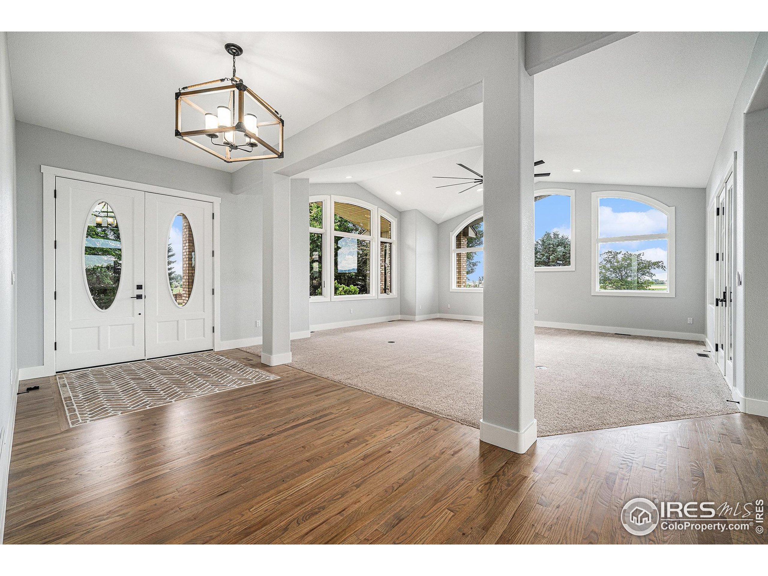 796 Abrams Way Berthoud, CO 80513 - Photo 4 of 40 a view of a livingroom with wooden floor and chandelier