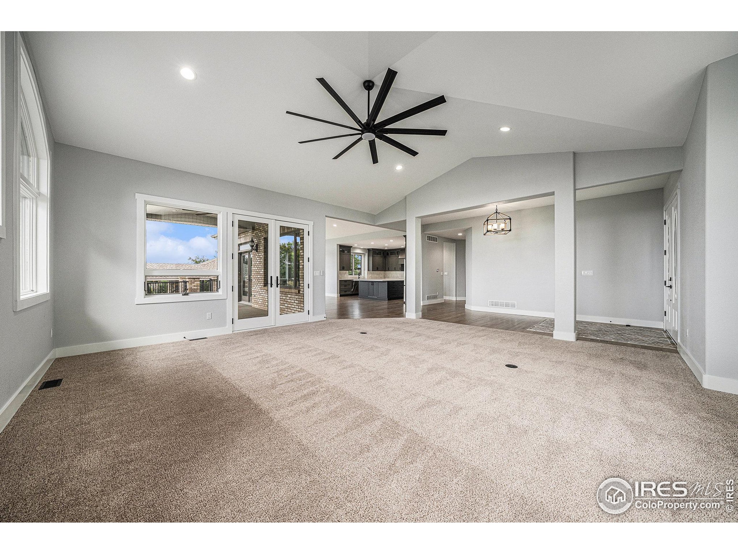796 Abrams Way Berthoud, CO 80513 - Photo 5 of 40 a view of a livingroom with a chandelier fan and windows