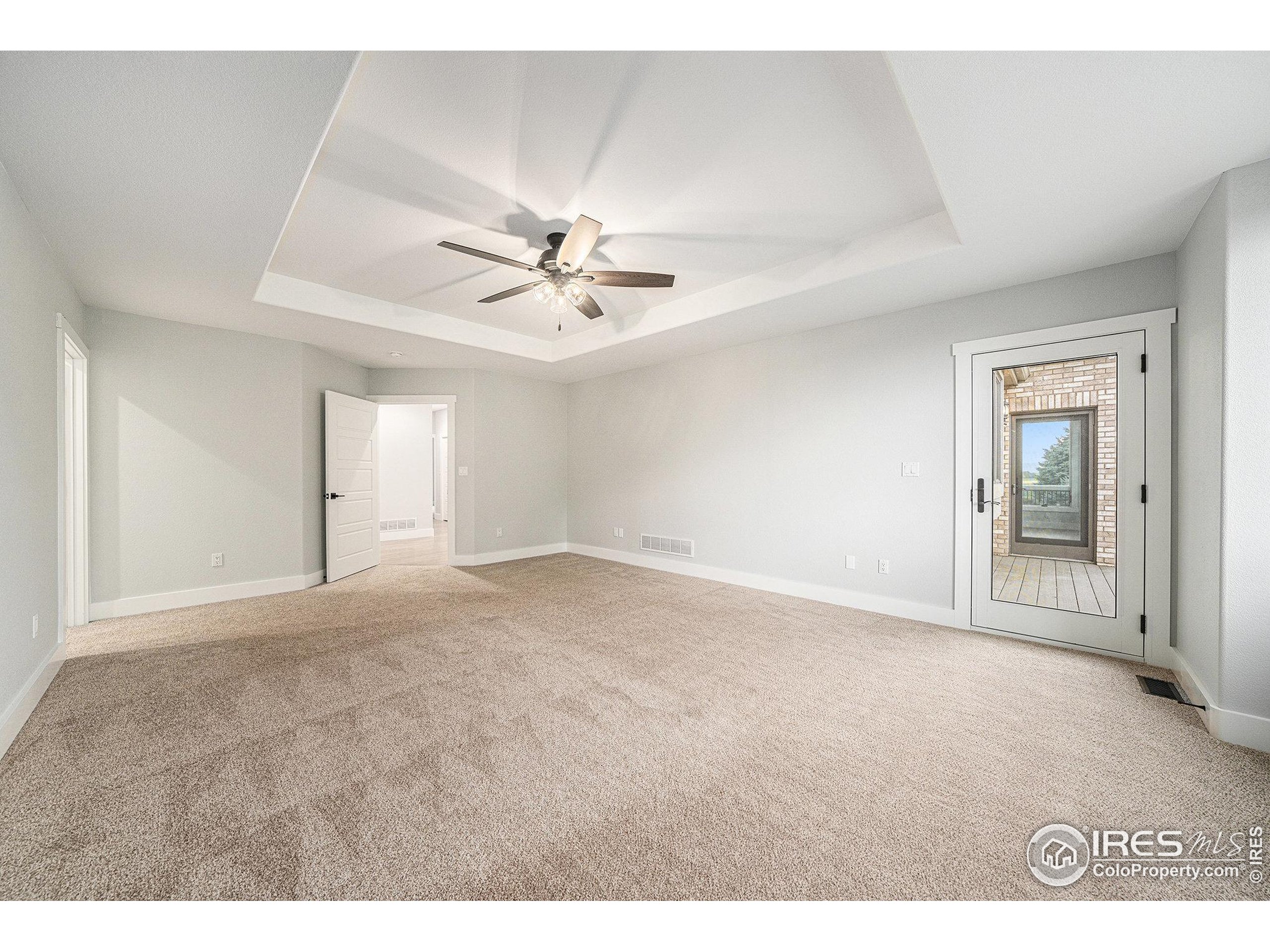 796 Abrams Way Berthoud, CO 80513 - Photo 9 of 40 a view of an empty room with a chandelier fan