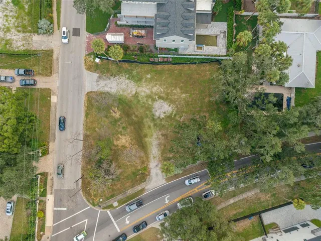 an aerial view of residential houses with outdoor space and lake view