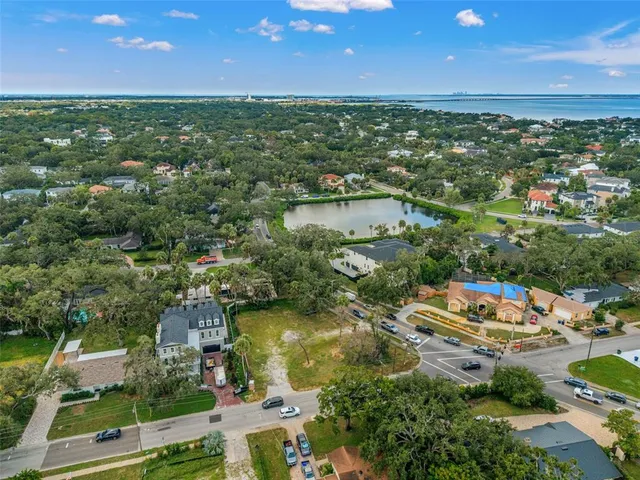 an aerial view of residential houses with city and outdoor space