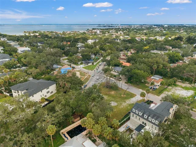 an aerial view of residential houses with outdoor space and swimming pool
