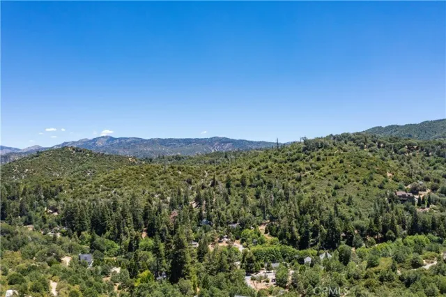 a view of a large mountain with mountains in the background
