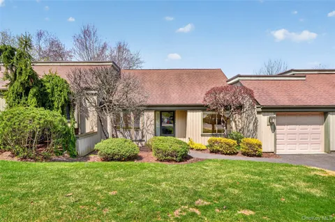 a view of a house with backyard and a garden