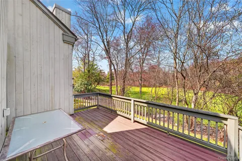 a view of backyard with a garden and deck