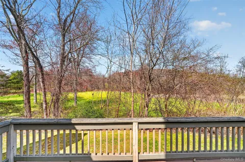 a view of a field with trees in the background