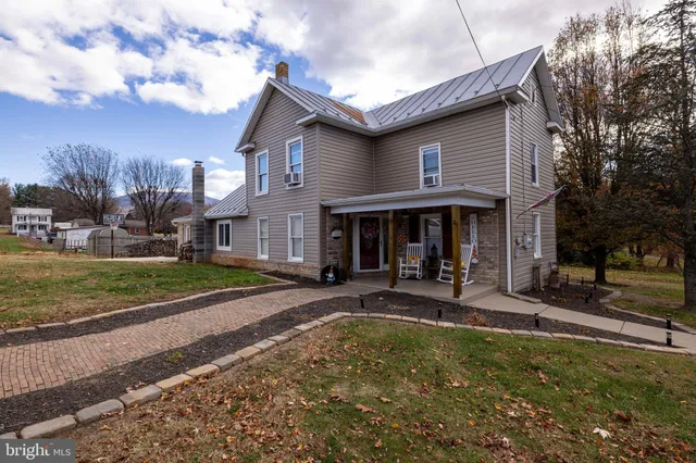 a view of a house with sitting area and swimming pool