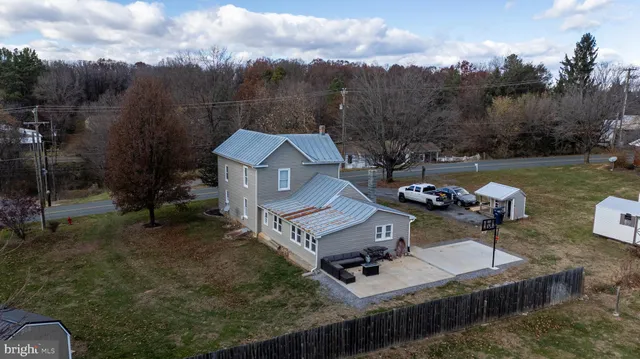 a view of a house with patio and backyard