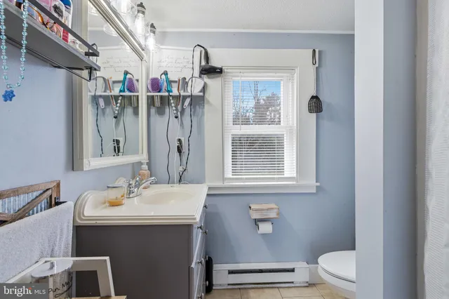 a bedroom with bed and a chandelier