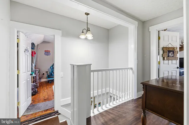 a view of a patio with table and chairs and a barbeque