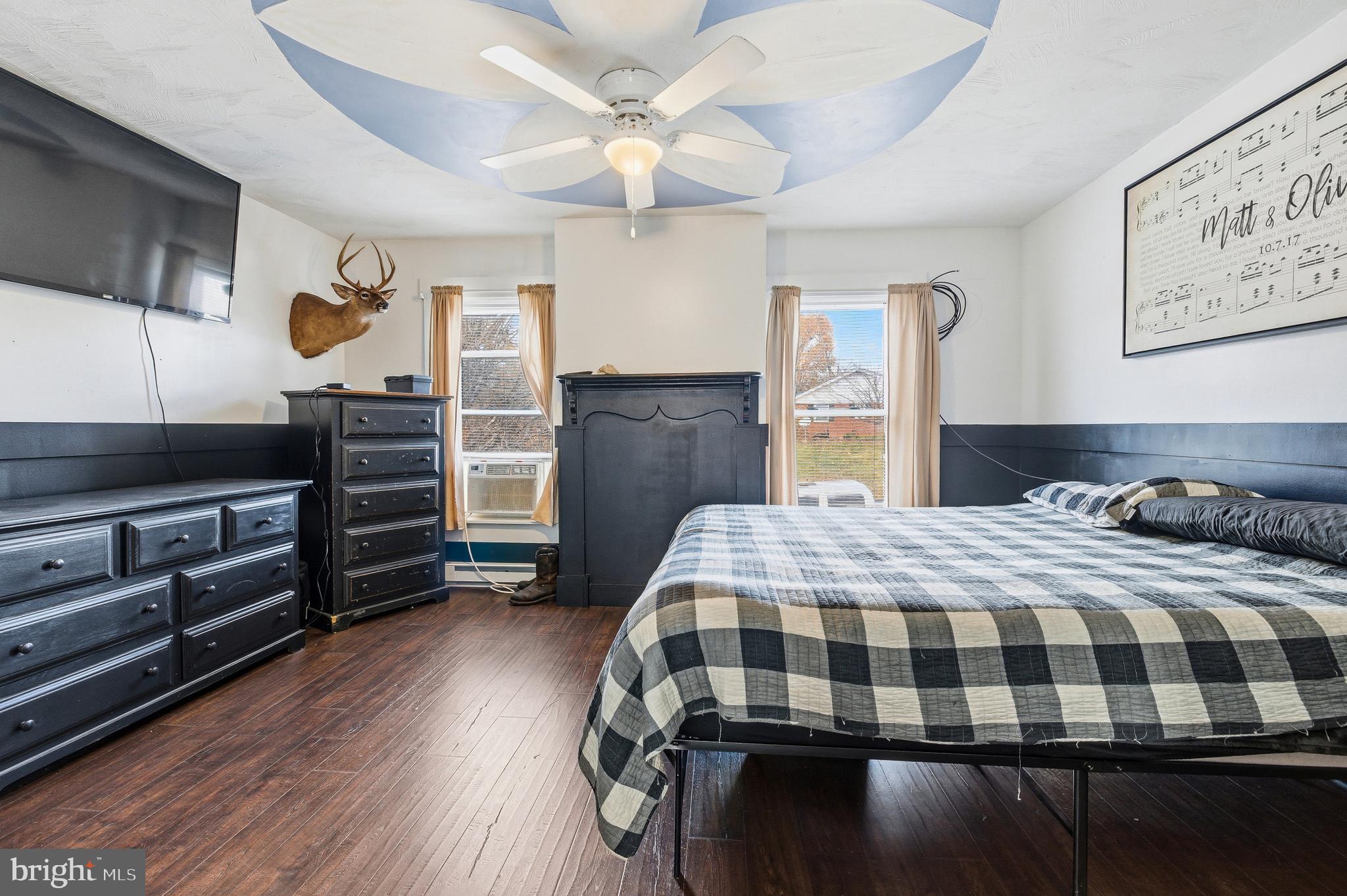 214 Chapel Road Stanley, VA 22851 - Photo 33 of 74 a bedroom with a bed and wooden floor