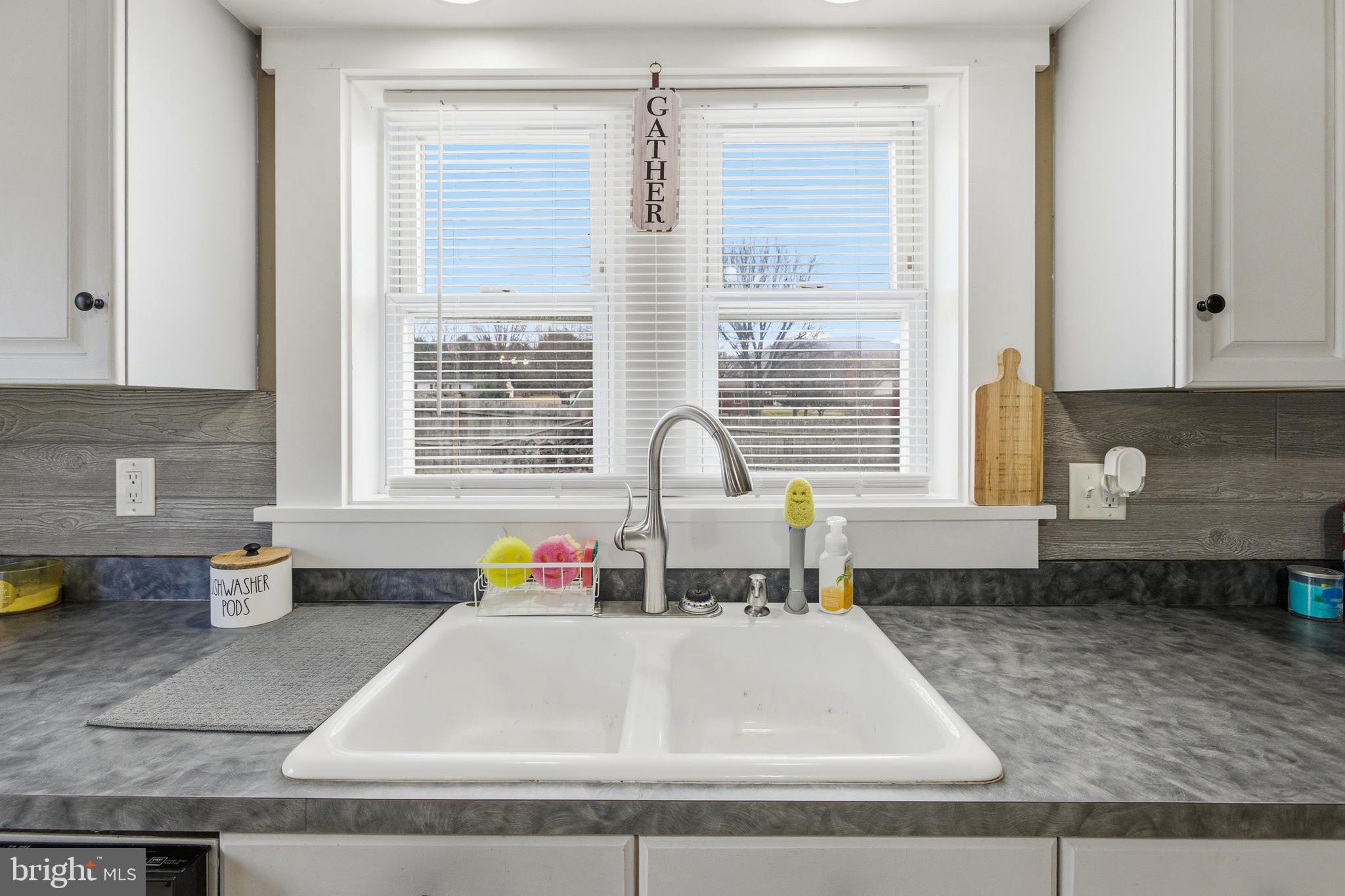 214 Chapel Road Stanley, VA 22851 - Photo 9 of 74 a kitchen with a window and cabinets