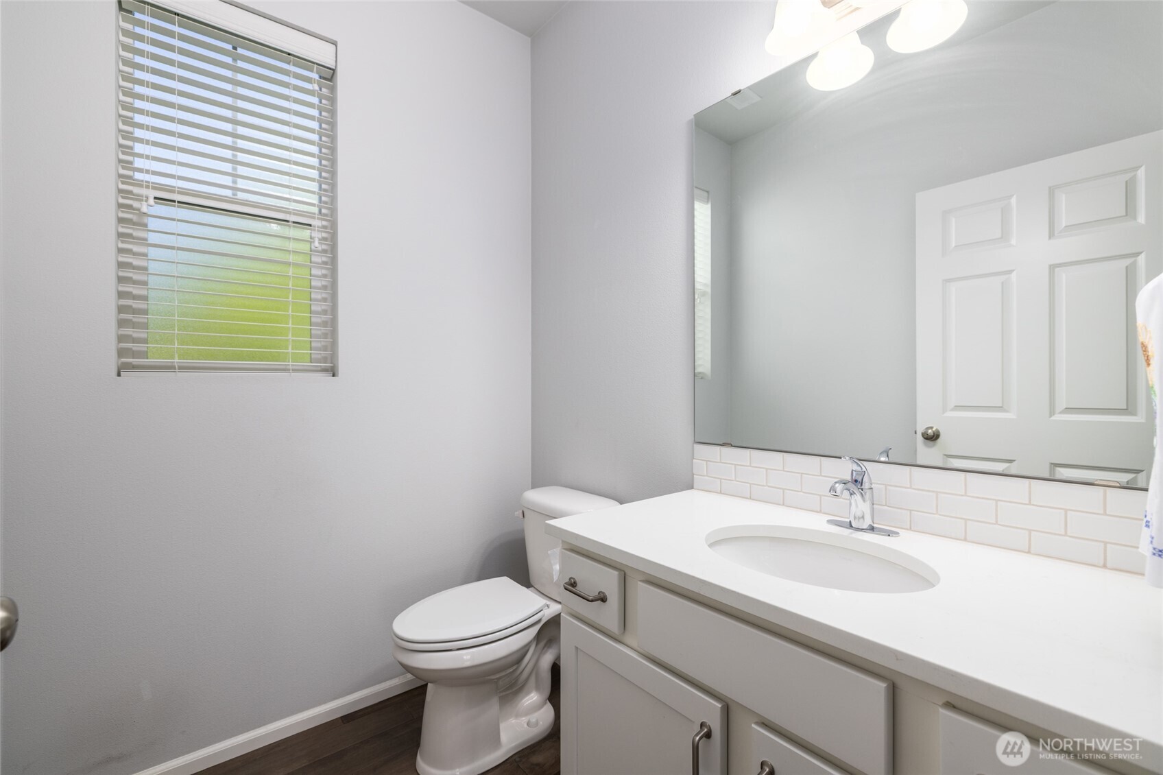 232 Sinclair Alley Mount Vernon, WA 98274 - Photo 12 of 33 a bathroom with a sink a toilet and a mirror