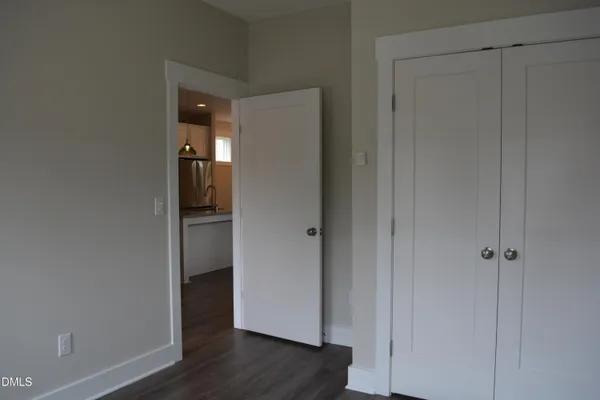 a bathroom with a granite countertop toilet a sink and shower