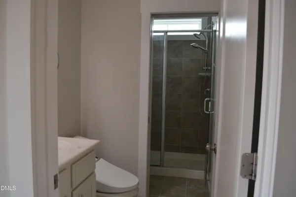 a white toilet sitting next to a bathroom sink