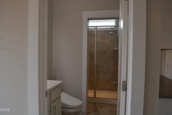 a bathroom with a glass shower door