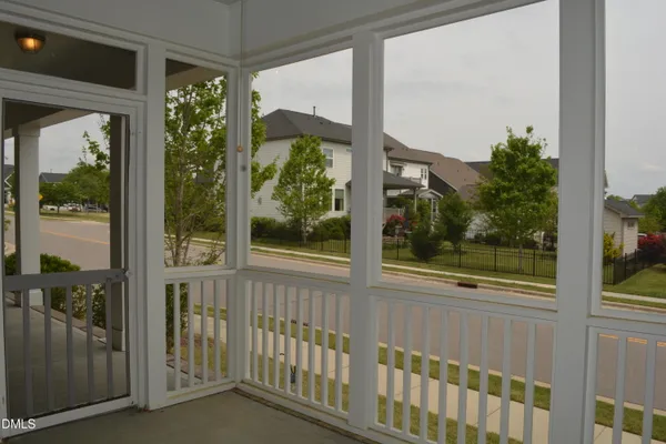 a view of a glass door and chair in the balcony