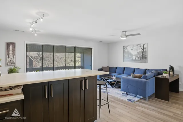a living room with furniture window and wooden floor