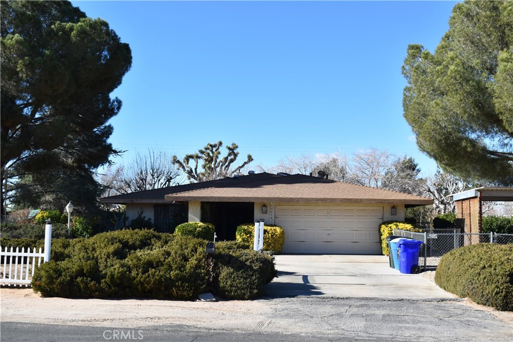 13434 Tioga Road Apple Valley, CA 92308 - Photo 1 of 1 a front view of a house with a garden and lake view