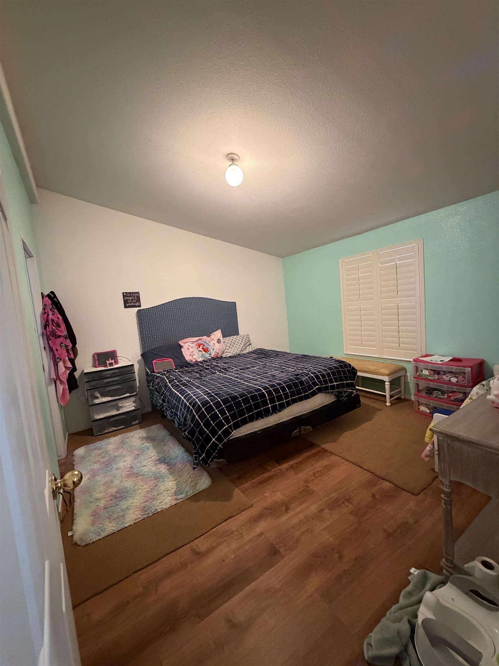 10100 Pioneer Trail, Unit 76 Reno, NV 89503 - Photo 17 of 22 a bedroom with a bed and wooden floor