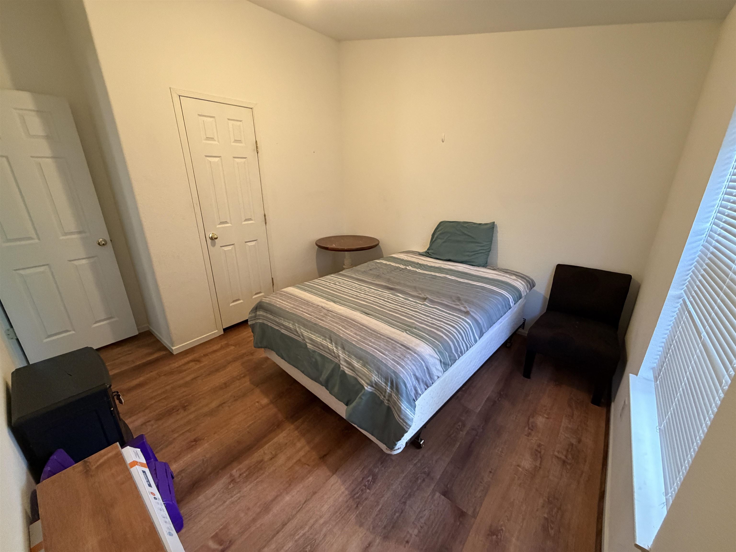 10100 Pioneer Trail, Unit 76 Reno, NV 89503 - Photo 20 of 22 a bedroom with a bed and wooden floor