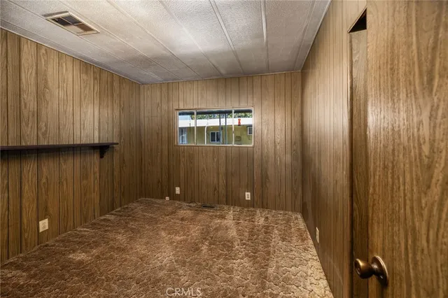 a view of a room with a wooden door