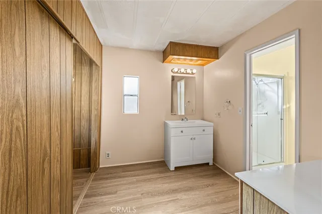 a bathroom with a sink a mirror and a shower