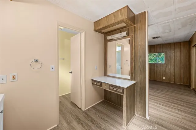 a white toilet sitting next to a white wall