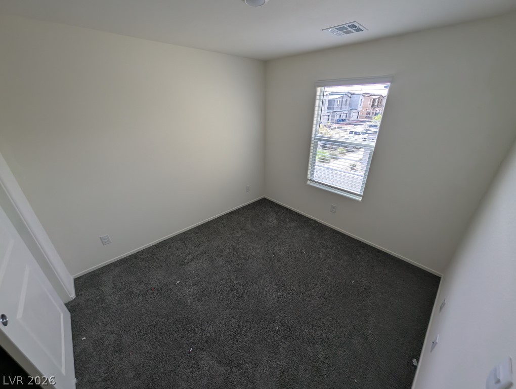 4820 Orchid Rdg Avenue Las Vegas, NV 89141 - Photo 11 of 16 A well-lit bedroom with fresh, neutral walls and soft carpeting invites restful slumber.