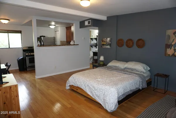 a bedroom with a bed and mirror