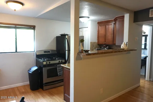 a kitchen with stainless steel appliances granite countertop a refrigerator and a stove