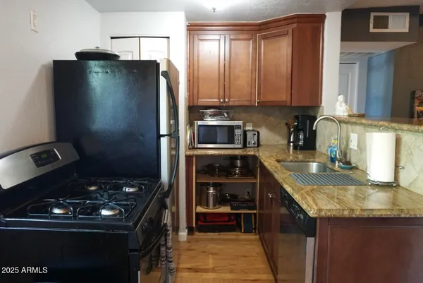 a kitchen with a refrigerator and a sink