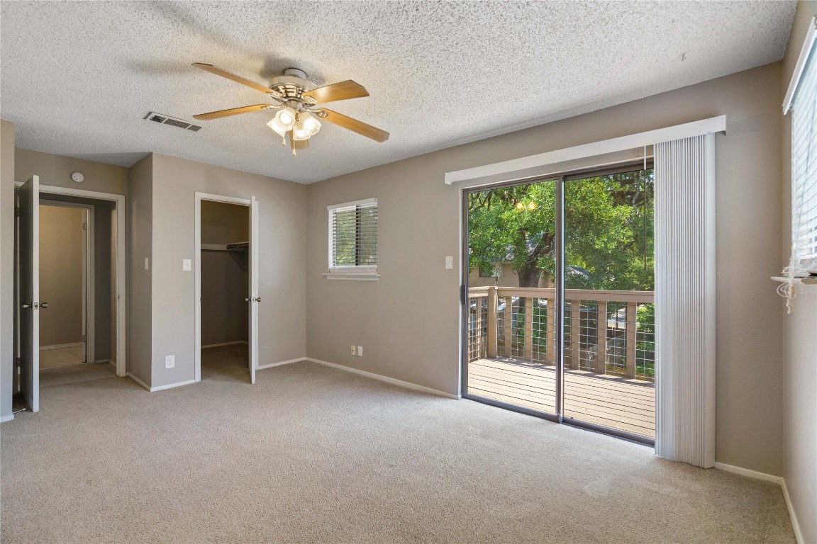 8005 Hood Circle, Unit B Austin, TX 78745 - Photo 14 of 18 an empty room with windows and fan