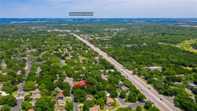a view of a city with lush green forest